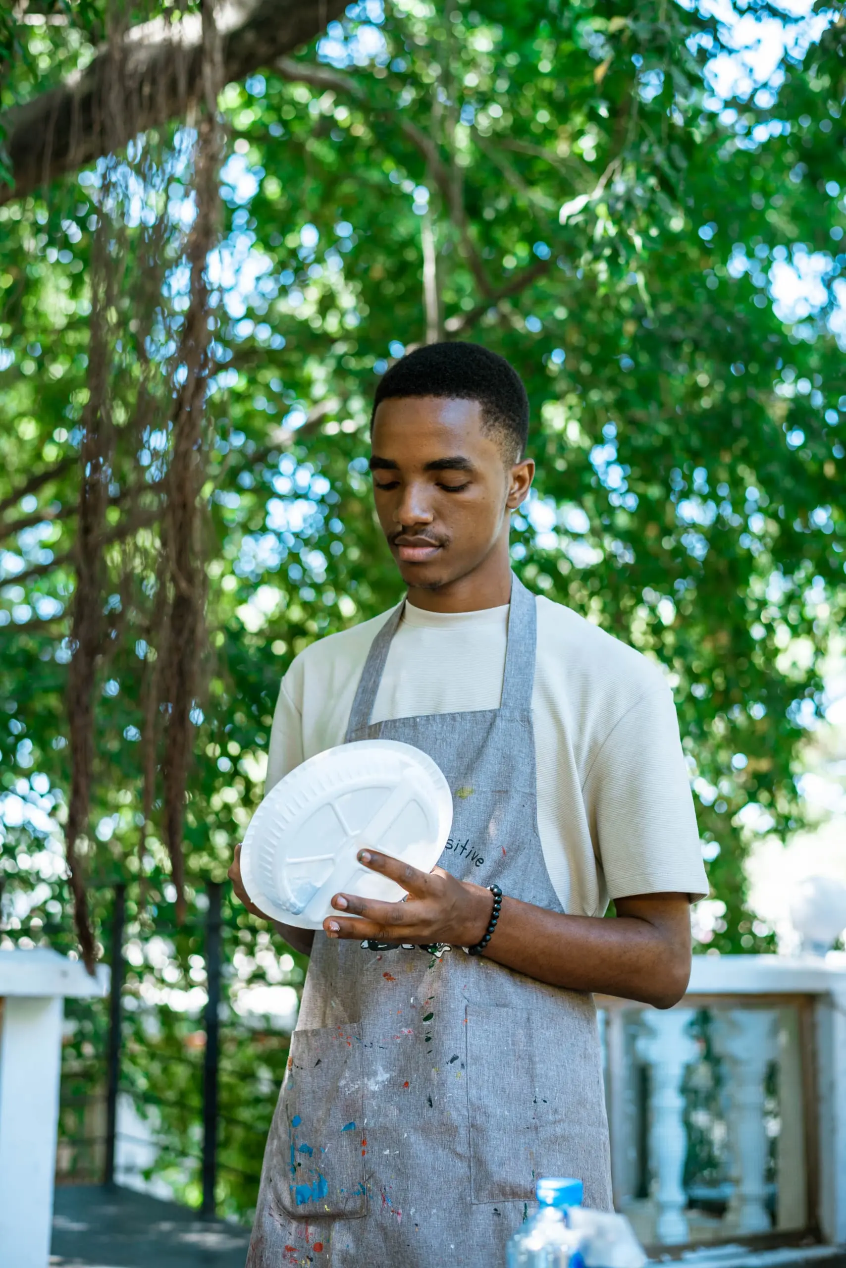 Henry Kirenga at exhibition with his artwork