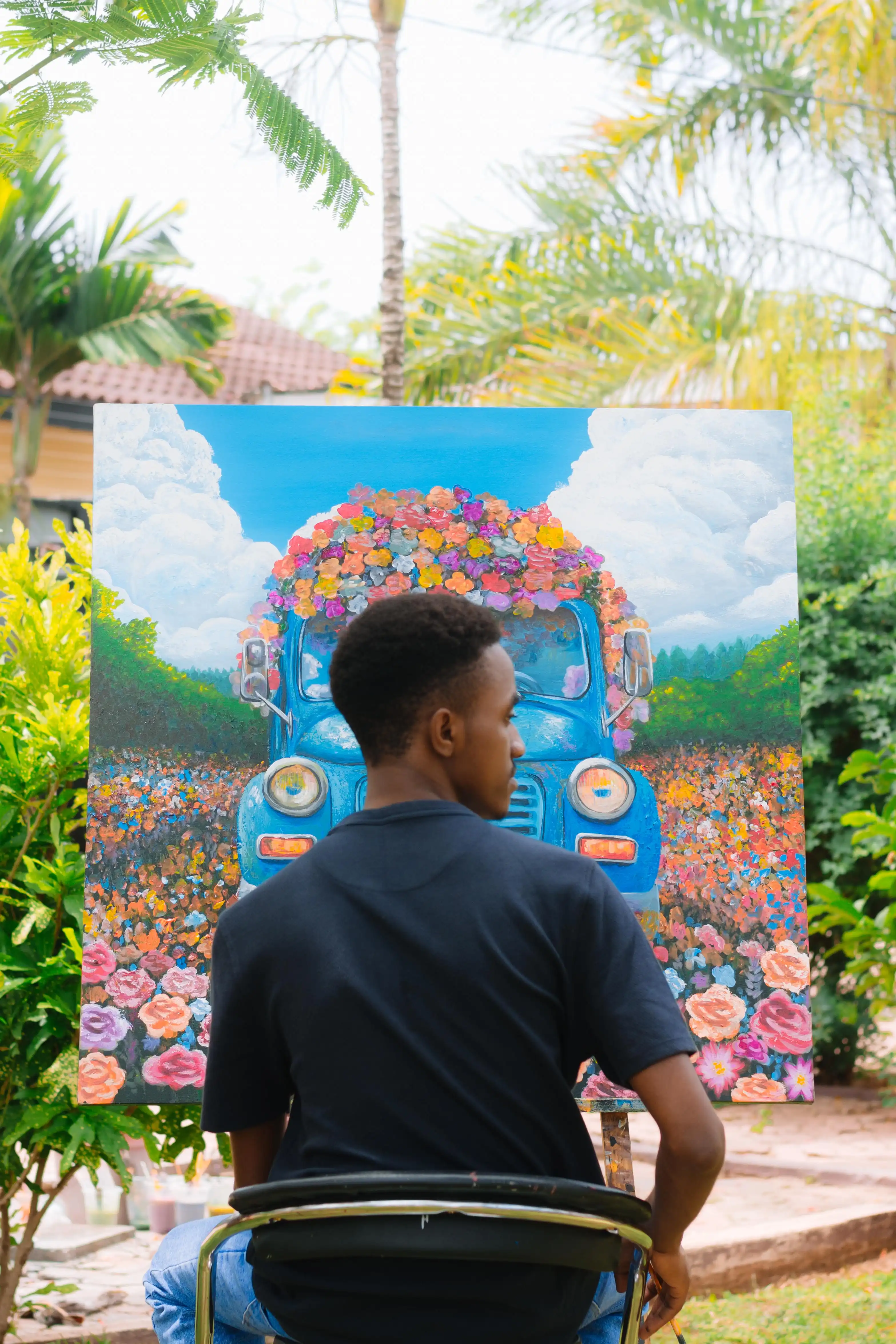 Henry Kirenga working in his studio with palette knives